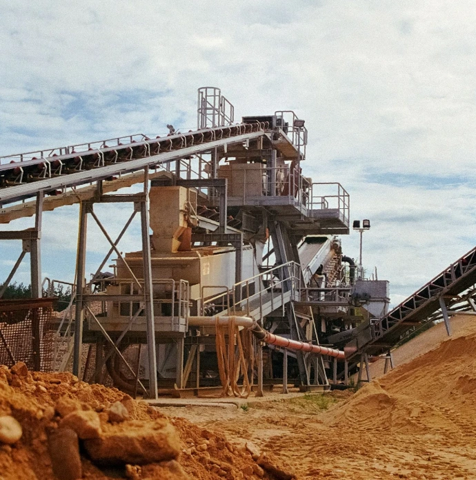 a large cement plant sitting on top of a dirt hill